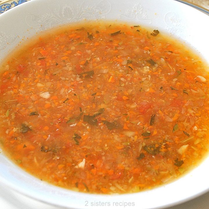 A white bowl filled with vegetable soup.
