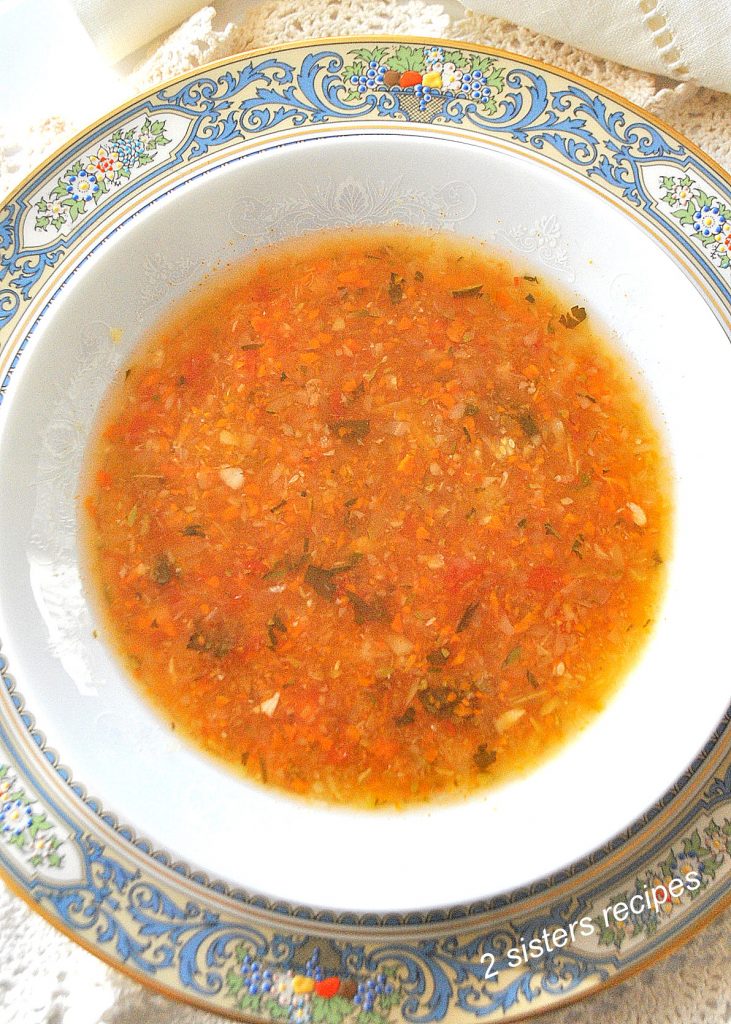 A white bowl filled with a vegetable soup.