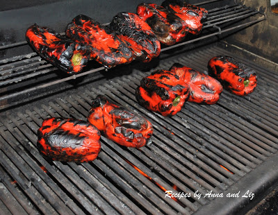 Roasting red bell peppers on an outside grill. 