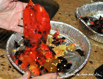 Peeling off the charred skins from the peppers.