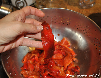 Holding one slice of a cleaned roasted red pepper. 