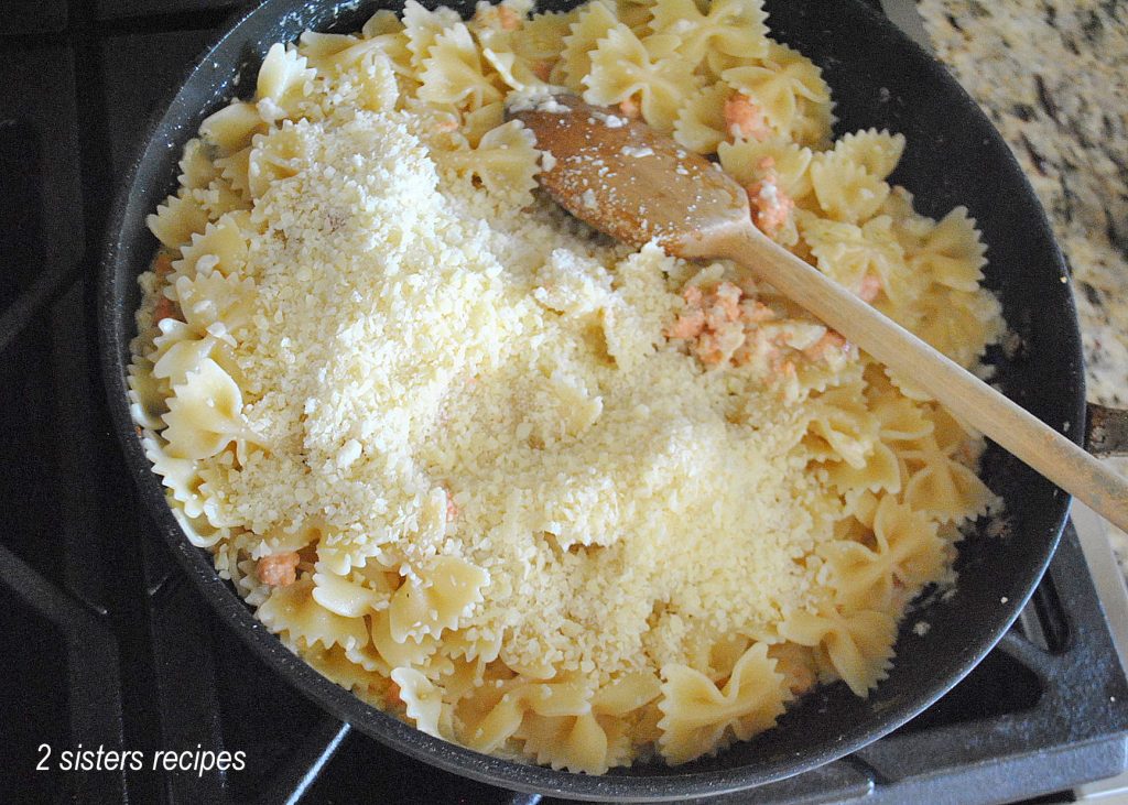 Pasta is simmering in a skillet with the salmon mixture by 2sistersrecipes.com 