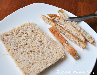 A slice of bread with crust cut off on all 4 sides on a white plate. by 2sistersrecipes.com 