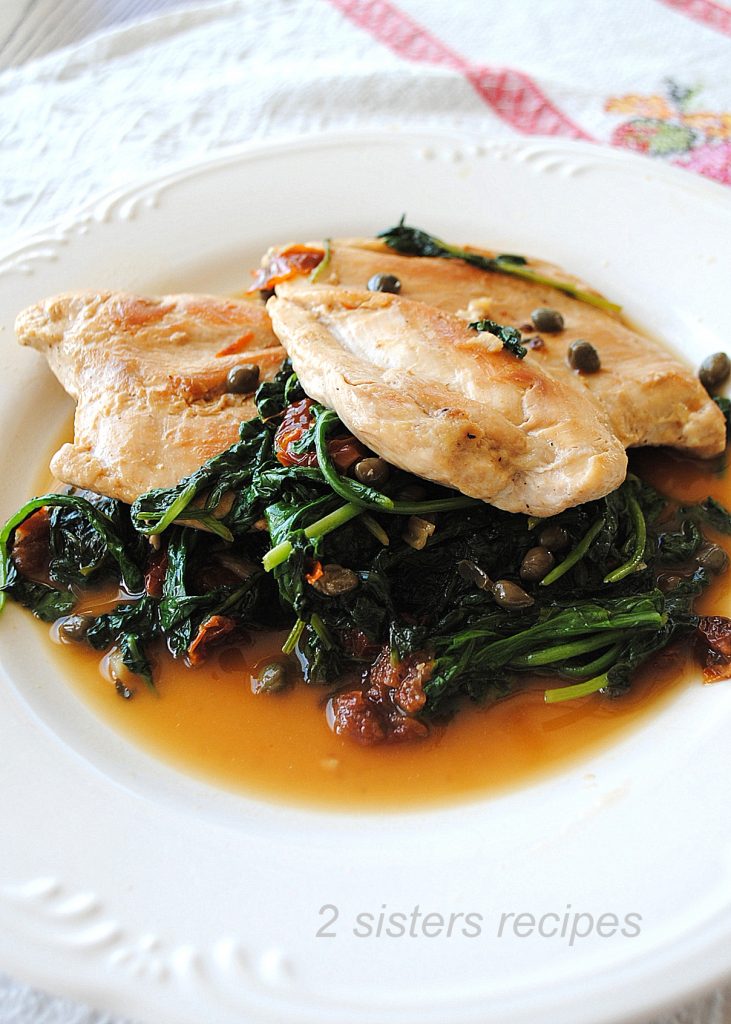 Chicken with Arugula served on a white dinner plate.