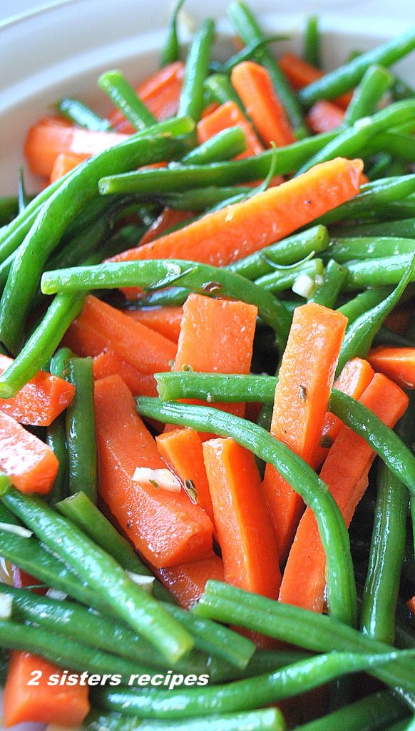 A platter filled with a mixture of green beans and carrots. -Italian Style! by 2sistersrecipes.com 