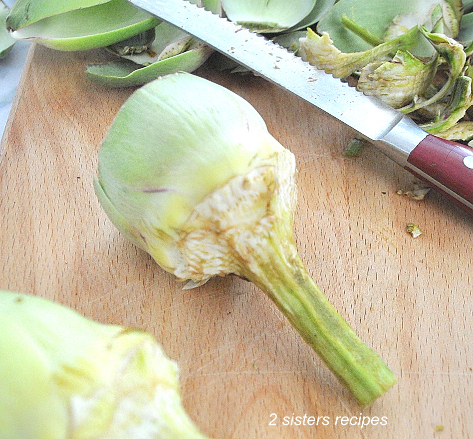 Stems of the artichokes have been peeled off and ends cut off.