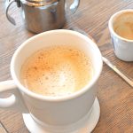 A white mug filled with a caffe latte.