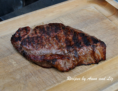 London broil sitting on a wood carving board, resting, before we carve it. 