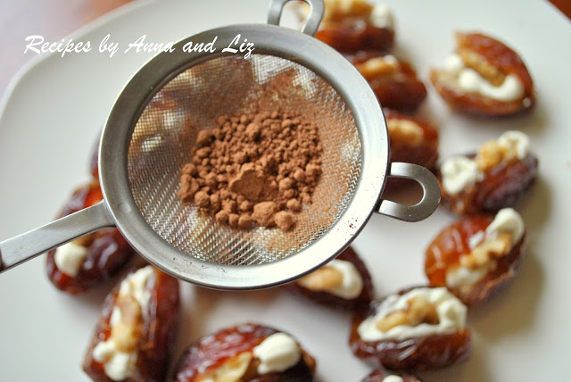 cocoa powder in a stainer over a dish of stuffed dates, by 2sistersrecipes.com 