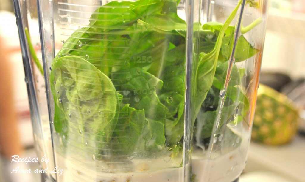 Bunch of fresh spinach is tossed into a blender. by 2sistersrecipes.com 