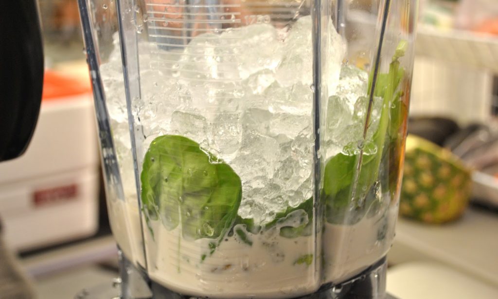 Bunch of ice cubes tossed into the blender for pistachio Ice cream. by 2sistersrecipes.com
