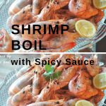 Boiled shrimp are served on a large platter with lemon slices.