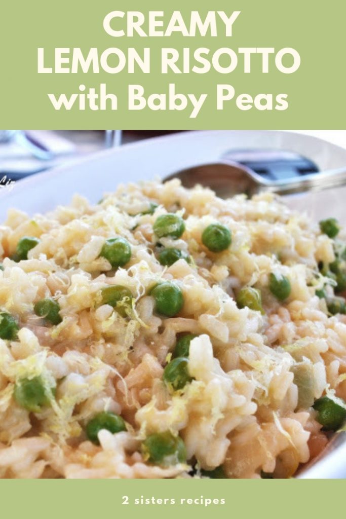 An oval serving platter filled with cooked Italian rice, risotto with baby peas.