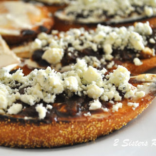 A slice of toasted bread topped with jam and crumbled blue cheese on top.