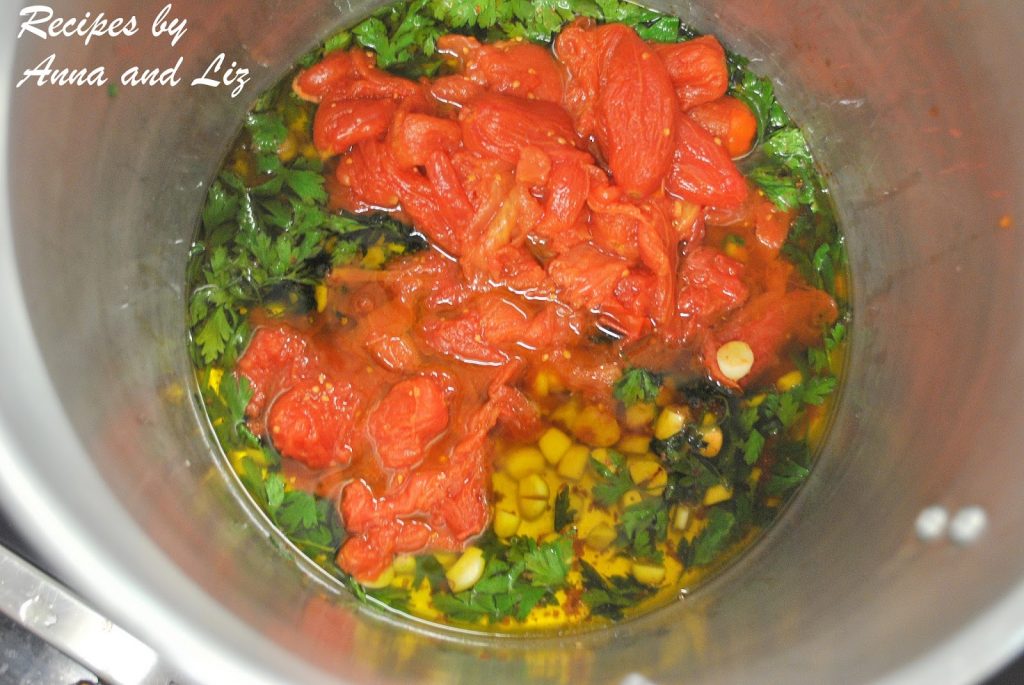 A pot filled with olive oil, plump tomatoes, parsley and garlic. by 2sistersrecipes.com