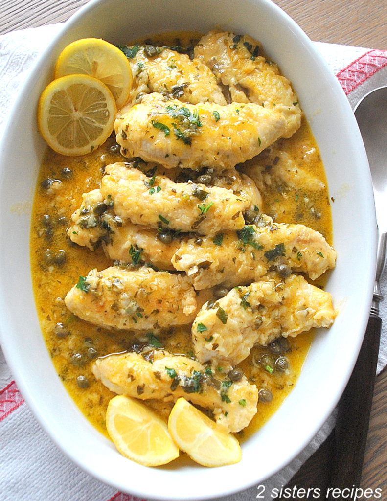 Chicken tenders in an oval serving platter. 