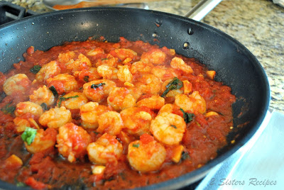 A photo showing the sauce and shrimp in a large skillet. by 2sistersrecipes.com 