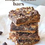 A pile of dark chocolate magic bars on white parchment paper.