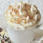 A white mug filled with whipped cream.