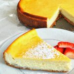 A slice of cheesecake served on a white plate.
