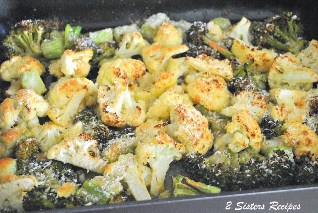 In a large roasting pan showing the broccoli and cauliflower. by 2sistersrecipes.com 