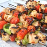 Grilled Ginger-Lime Chicken Kabobs served on a white plate.