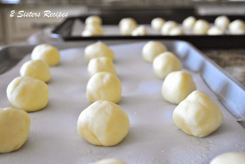 Gluten-Free Cheese Balls on a baking sheet by 2sistersrecipes.com 