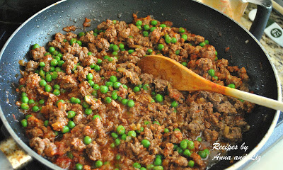 Skillet with meat and peas cooking on stovetop by 2sistersrecipes.com 