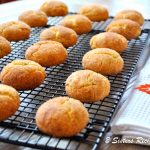 A wire rack filled with baked snickerdoodle cookies.