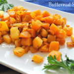 A white platter filled with cooked caramelized butternut squash.