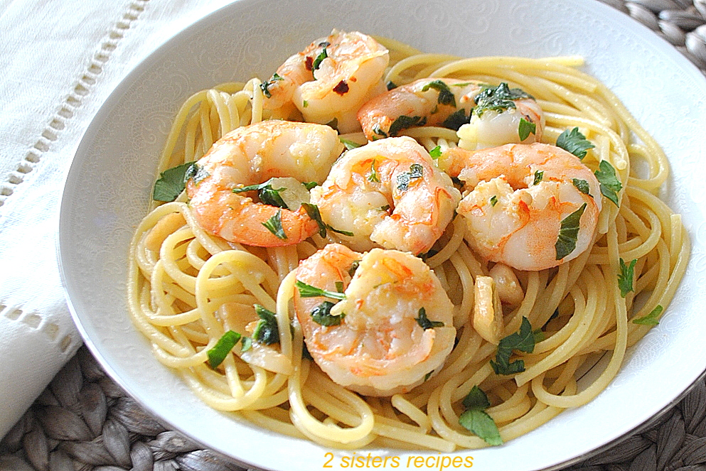 A bowl filled with spaghetti and shrimp  by 2sistersrecipes.com