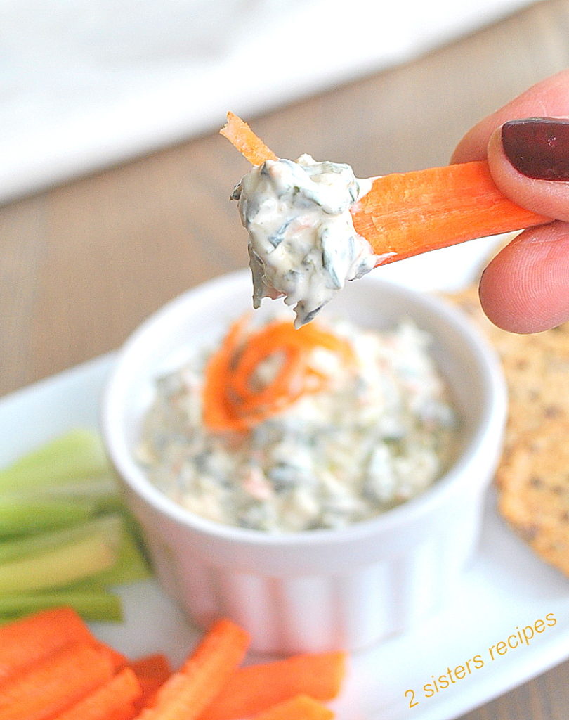 photo of a carrot stick with some dip on it. by 2sistersrecipes.com