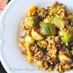 A white dinner plate with a serving if Brussels sprouts, quinoa and brown rice.