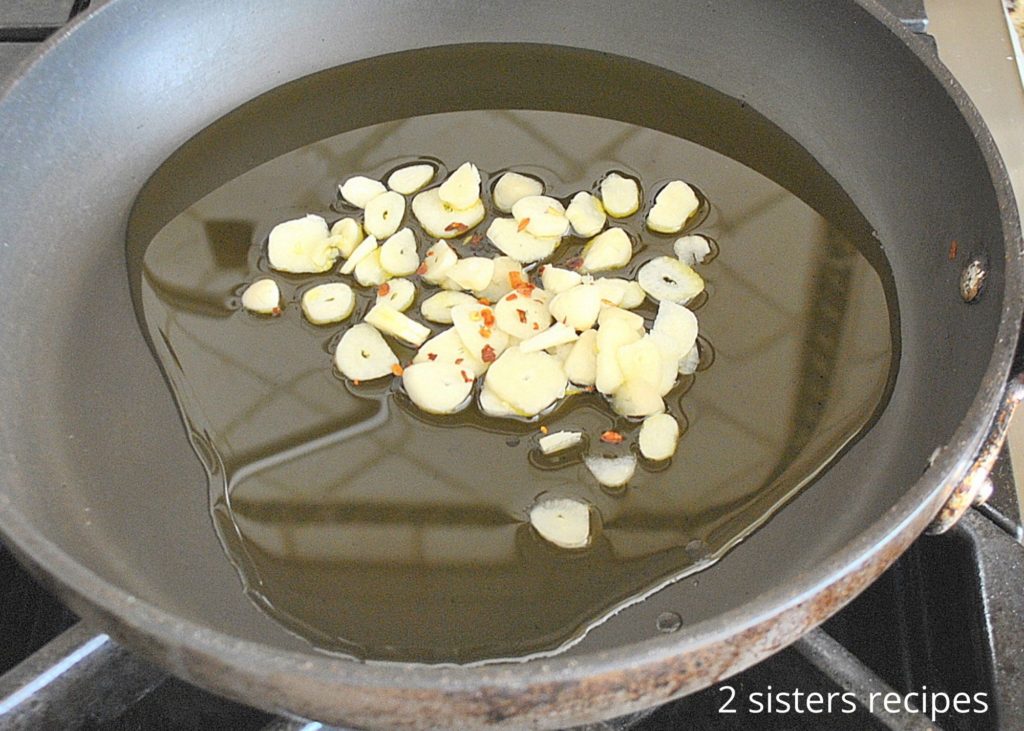 Sauteing olive oil and garlic in a skillet. by 2sistersrecipes.cpm 
