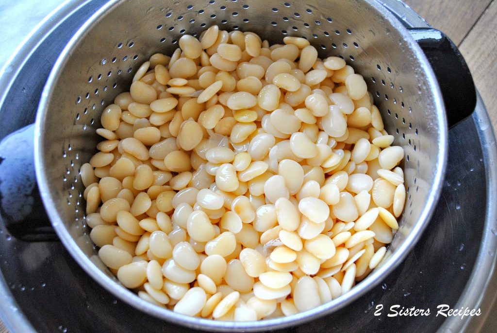 A silver colander filled with lima beans draining.  by 2sistersrecipes.com 