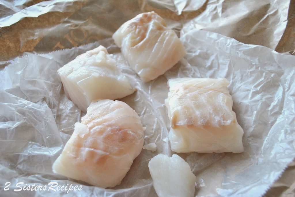 raw cod fish on wax paper. by 2sistersrecipes.com 