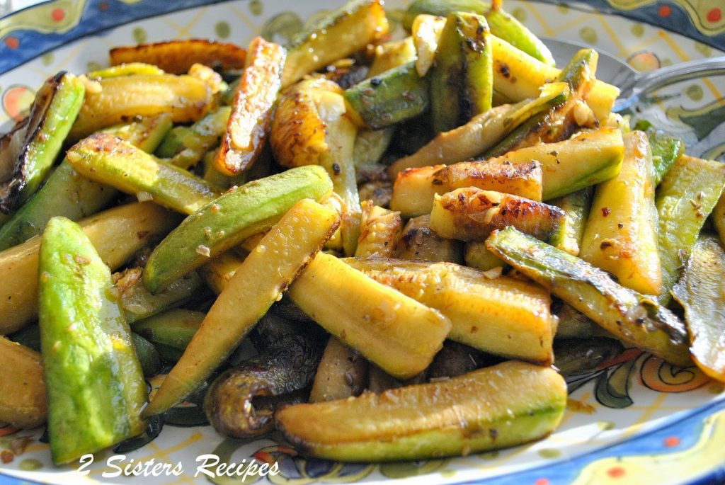 A serving colorful platter with sautéed zucchini sticks.