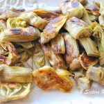Roasted frozen artichoke hearts served on a white platter.