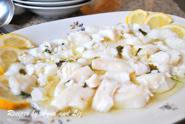 Platter of cod fish salad with lemon slices. by 2sistersrecipes.com
