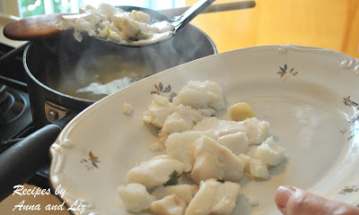 Transfer the drained cod fish into a white serving platter.  by 2sistersrecipes.com 