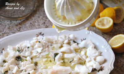 Fresh lemon juice is poured over a platter of fresh cod fish salad. by 2sistersrecipes.com