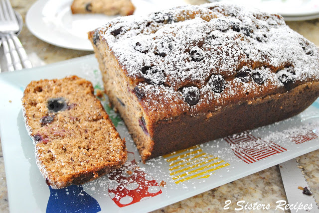 The Ultimate Blueberry Banana Bread sliced on a serving platter.