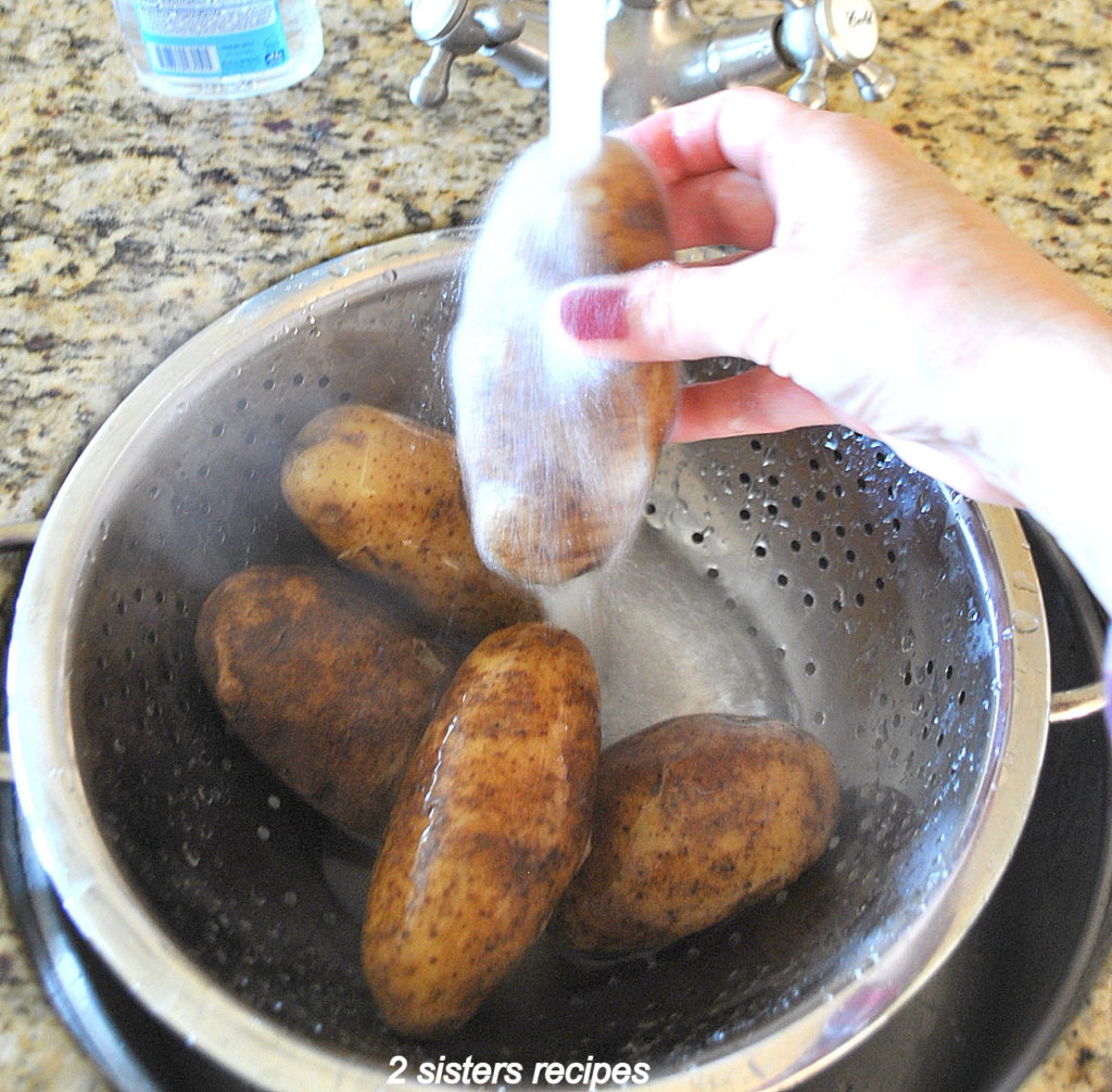 Running water over the cooked potatoes. by 2sistersrecipes.com 