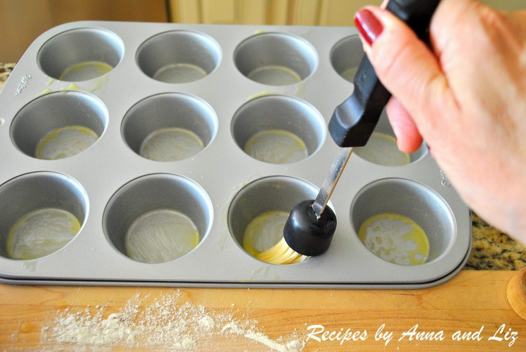 Brushing butter on the bottom of each muffin pan. by 2sistersrecipes.com 