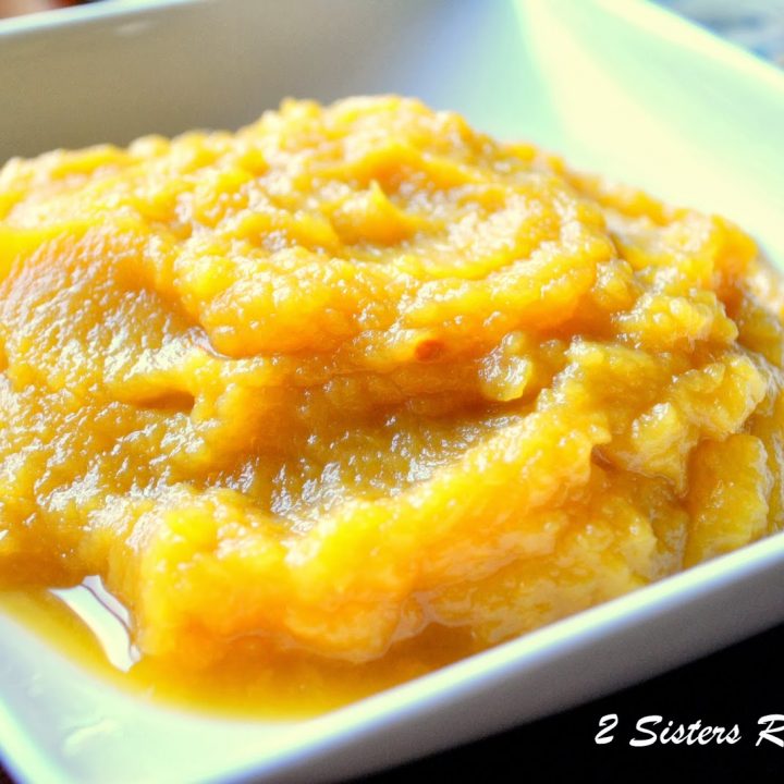 A square-shaped white bowl filled with fresh pumpkin puree.