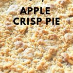 A fully baked apple pie with a crumble on top.