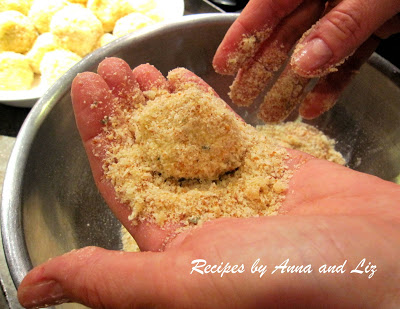Coating a ball of rice with bread crumbs by 2sistersrecipes.com 