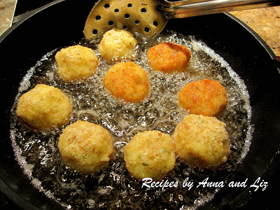 Frying several rice ballls in a black skillet on stovetop. by 2sistersrecipes.com 