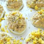 A white platter with deviled eggs.