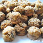 A white platter filled with baked stuffed mushroom caps.